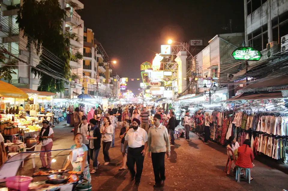 Khao San Road at night, with stalls and crowds along the street