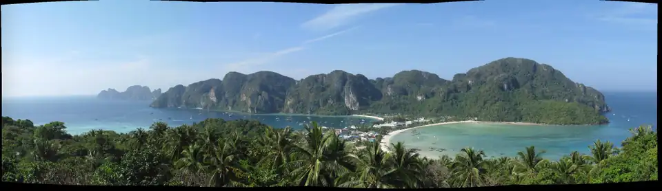 Panorama from the Phi Phi viewpoint showing two bays either side of a narrow sandy neck with the village built across it