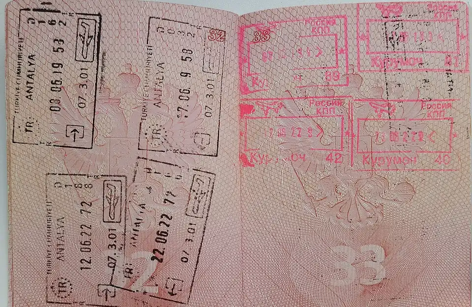 An open passport filled with entry and exit stamps