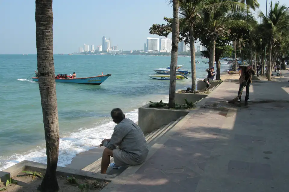 The promenade along Pattaya Beach, with the city skyline across the bay