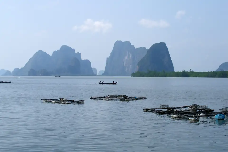 Fish farms in front of karst islands in the bay
