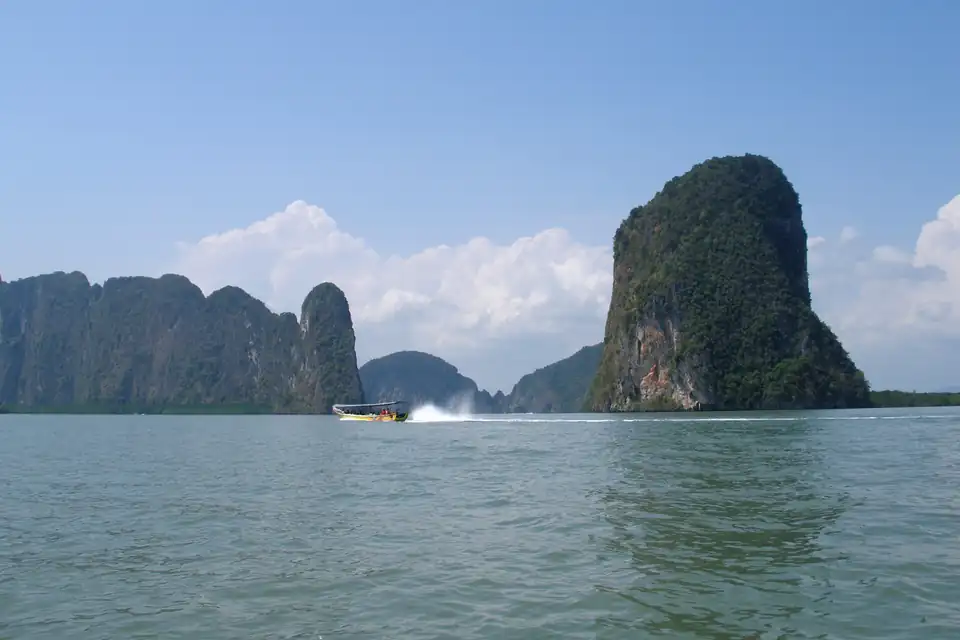 A speedboat between karst islands