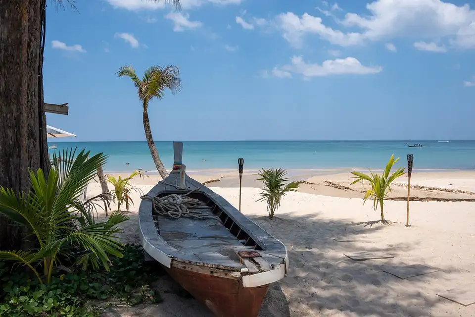 An old longtail on the sand at Bang Tao
