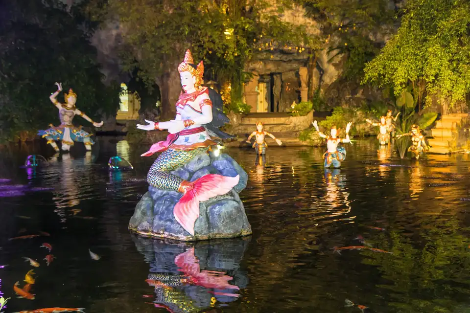 A statue in the lake at night