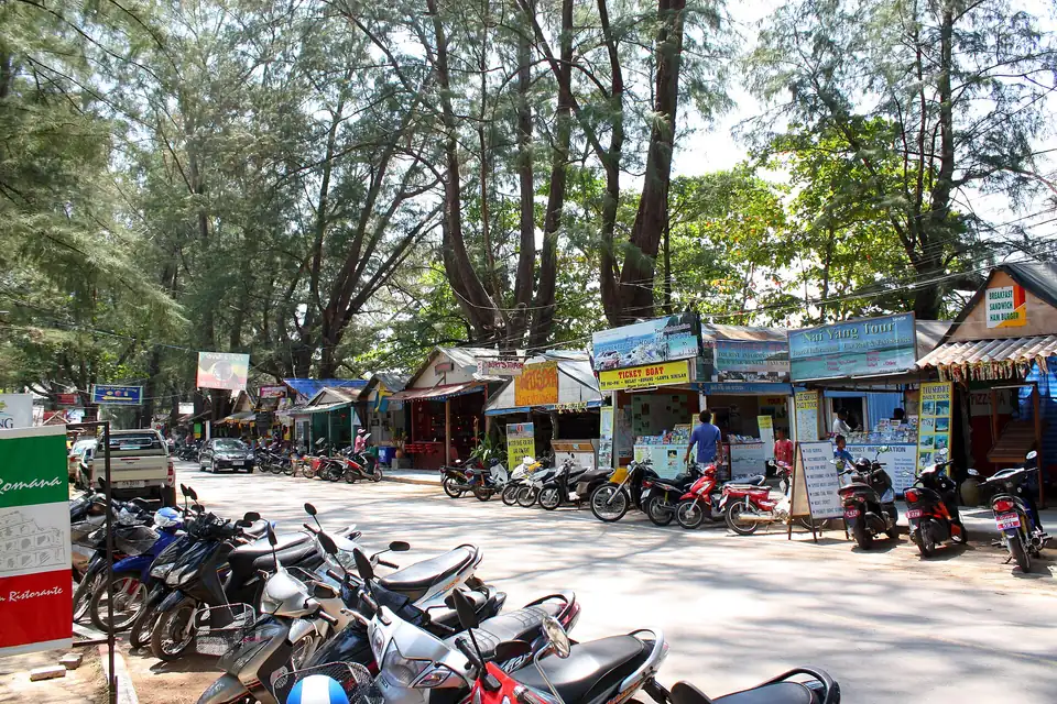 The strip of shops under the pines behind Nai Yang