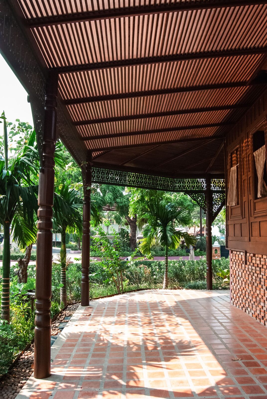 A traditional Thai teak house veranda and garden