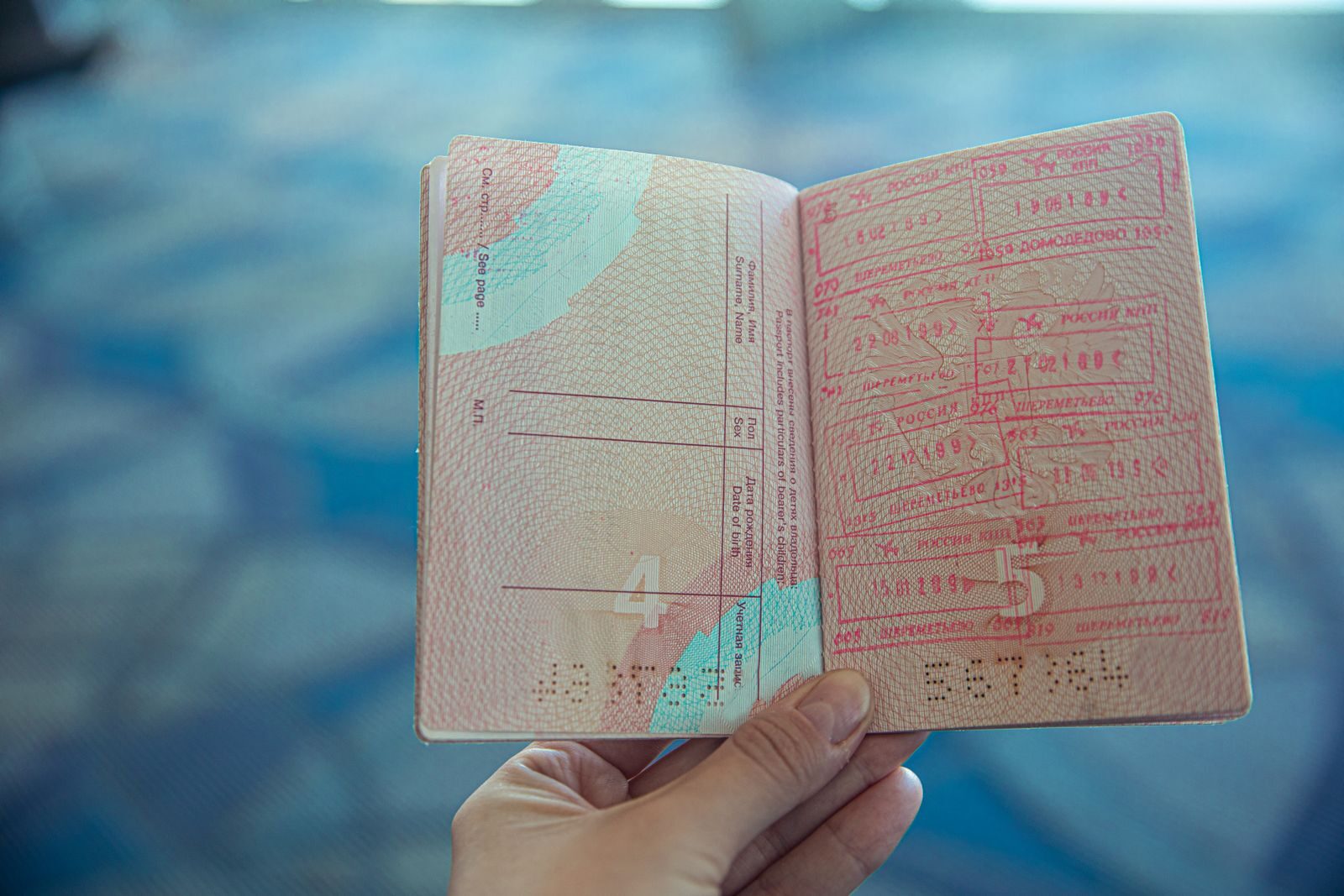 An open passport filled with entry and exit stamps